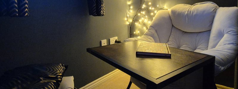 chair with fairy lights and a notepad, reading nook